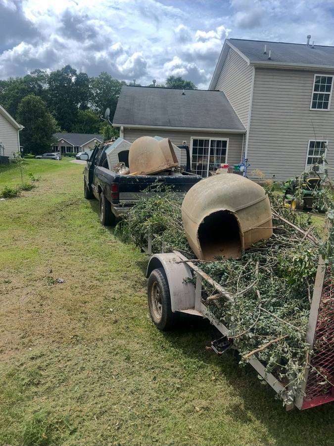 M&I hauling truck with concrete tanks and yard debris Anderson SC
